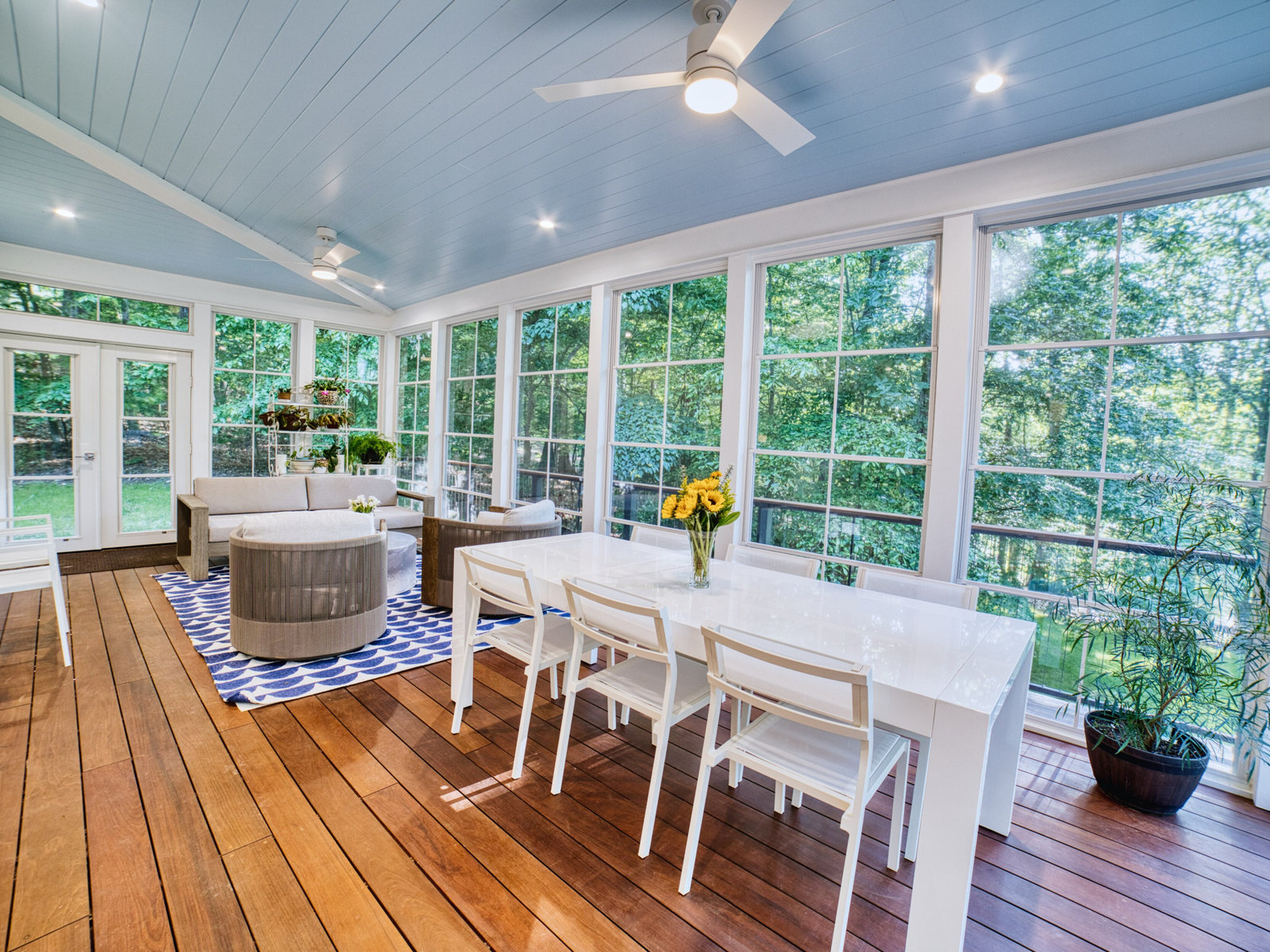 Pond Renovation in Alpharetta, GA by All-Square Contracting — screened porch with pale blue beadboard ceiling, wood flooring and dining table